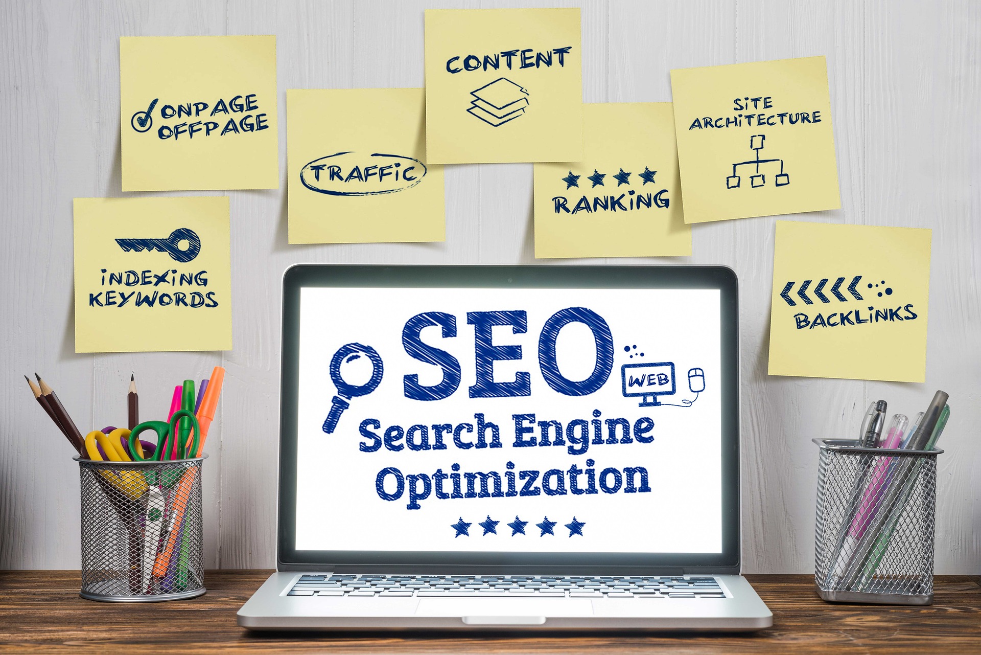 seo written on a laptop with multiple sticky notes.